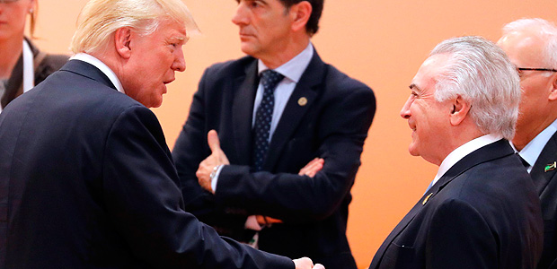 US President Donald Trump (L) shakes hands with Brazil's President Michel Temer at the beginning of the third working session of the G20 meeting in Hamburg, northern Germany, on July 8, 2017.?The G20 summit wraps up, with world leaders seeking to reach an agreement on a final joint statement despite divisions with US President Donald Trump over trade and climate change. / AFP PHOTO / AFP PHOTO AND POOL / LUDOVIC MARIN / SOLELY FOR REUTERS AND EPA