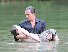 Ferrao se joga no lago e salva Renato de afogamento na novela "Duas Caras", da Globo