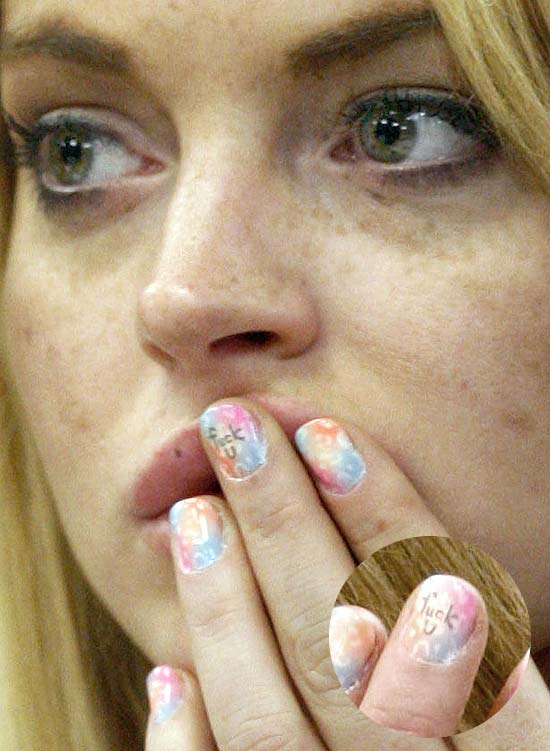 ** EDS NOTE: OBSCENE LANGUAGE ON LEFT MIDDLE FINGERNAIL ** RECROPPED VERSION** FILE - In this July 6, 2010 file photo, profane language is seen on the middle fingernail of actress Lindsay Lohan during a hearing in Beverly Hills, Calif. The judge sentenced Lindsay Lohan to 90 days in jail Tuesday after ruling she violated probation in a 2007 drug case by failing to attend court-ordered alcohol education classes. (AP Photo/David McNew, Pool, File)