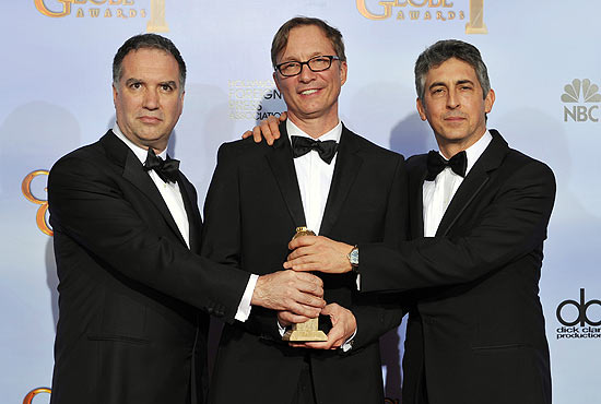 ORG XMIT: CACJ489 From left, Jim Taylor, Jim Burke and Alexander Payne pose backstage with the award for Best Motion Picture Drama for the film "The Descendants" during the 69th Annual Golden Globe Awards Sunday, Jan. 15, 2012, in Los Angeles. (AP Photo/Mark J. Terrill)