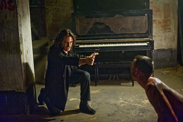 Os atores dgar Ramrez (com crucifixo) e Chris Coy em cena do longa 'Livrai-nos do Mal