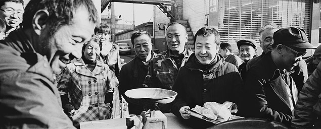 O cineasta chins Jia Zhangke, ao centro, com bandeja