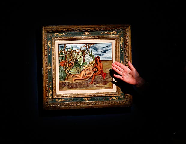(FILES) This file photo taken on April 29, 2016 shows an Art specialist at Christie's speaks about the artwork 'Dos desnudos en el bosque (La Tierra Misma)' made by artist Frida Kahlo during a press preview in New York. A painting by Frida Kahlo depicting two nude women sold Thursday in New York for a record $8 million, the highest price yet for any work by the iconic Mexican artist, Christie's said. The 1939 painting "Dos desnudos en el bosque (La tierra misma)" was estimated to be worth $8 to $12 million. Despite selling at the bottom of that range, it supassed Kahlo's previous auction record. / AFP PHOTO / KENA BETANCUR / RESTRICTED TO EDITORIAL USE - MANDATORY MENTION OF THE ARTIST UPON PUBLICATION - TO ILLUSTRATE THE EVENT AS SPECIFIED IN THE CAPTION / XGTY ORG XMIT: KB26