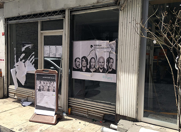 A ripped up poster advertising the streaming event of Radiohead's new album, at a record shop, in Istanbul, Saturday, June 18, 2016. Turkish media report a mob of 20 assailants carrying sticks and bottles attacked Radiohead fans who had gathered at a record store in Istanbul to listen to the band's new album. The private Dogan news agency reported Saturday that one person was wounded in the incident Friday at the Velvet Indieground record shop. (AP Photo/Dominique Soguel) ORG XMIT: ANK101