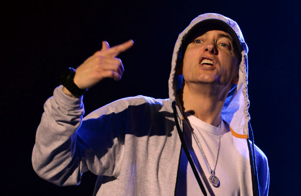 (FILES) This file photo taken on August 22, 2013 shows US rapper Eminem during a concert at the Stade de France in Saints-Denis, near Paris. Rap superstar Eminem re-emerged on October 19, 2016 with a loaded lyrical attack on Donald Trump, in a nearly eight-minute song in which he also identifies with the Black Lives Matter cause. The top-selling rapper of all time, Eminem has been relatively quiet in the past several years but wrote on Facebook that he was working on a new album. / AFP PHOTO / Pierre ANDRIEU ORG XMIT: 705