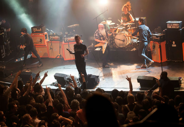 TOPSHOTS American rock group Eagles of Death Metal perform on stage on November 13, 2015 at the Bataclan concert hall in Paris, few moments before four men armed with assault rifles and shouting "Allahu akbar" ("God is great!") stormed into the venue. Islamic State jihadists on November 14, 2015 claimed a series of coordinated attacks by gunmen and suicide bombers in Paris that killed at least 128 people in scenes of carnage at the Bataclan, restaurants and the national stadium. AFP PHOTO / ROCK&FOLK / MARION RUSZNIEWSKI ORG XMIT: -01