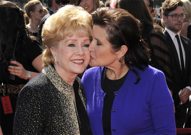 FILE- In this Sept. 10, 2011, file photo, Debbie Reynolds, left, and Carrie Fisher arrive at the Primetime Creative Arts Emmy Awards in Los Angeles. Reynolds, star of the 1952 classic "Singin' in the Rain" died Wednesday, Dec. 28, 2016, according to her son Todd Fisher. She was 84. (AP Photo/Chris Pizzello, File) ORG XMIT: NYDR107