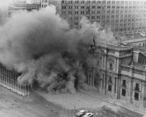 FILE - In this Sept. 11, 1973 file photo, La Moneda presidential palace is bombed during a military coup to oust President Salvador Allende after which Gen. Augusto Pinochet seized power in Santiago, Chile. As bombs fell and rebelling troops closed in on the national palace, Allende avoided surrender by shooting himself with an assault rifle, ending Chile's experiment in nonviolent revolution and beginning 17 years of dictatorship. (AP Photo/File) ORG XMIT: XLAT203