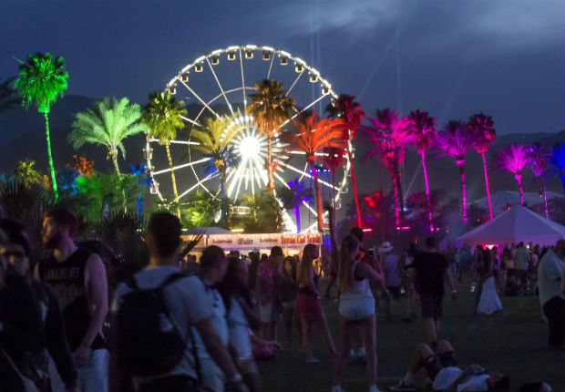 Colored lights illuminate palm trees on the first day of the Coachella Music Festival, in Indio, California, April 10, 2015. AFP PHOTO / ROBYN BECK ORG XMIT: RLB1376