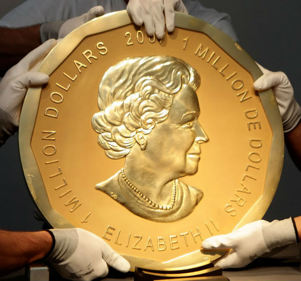 FILE PHOTO - Picture taken in Vienna, Austria on June 25, 2010 shows experts of an Austrian art forwarding company holding one of the world's largest gold coins, a 2007 Canadian $ 1,000,000 
