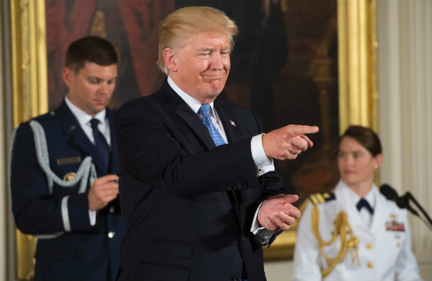 US President Donald Trump gestures as he presents the Medal of Valor to the first responders of the June 14 shooting against members of the Republican Congressional Baseball team, where US House Majority Whip Representative Steve Scalise, Republican of Louisiana, was shot, in the East Room of the White House in Washington, DC, July 27, 2017. 