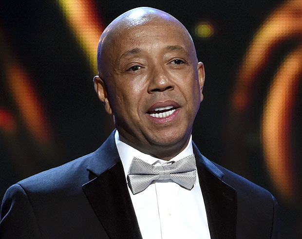 FILE - In this Feb. 6, 2015, file photo, hip-hop mogul Russell Simmons presents the Vanguard Award on stage at the 46th NAACP Image Awards in Pasadena, Calif. Simmons announced on Nov. 30, 2017, he would be stepping down from companies he founded following a new allegation of sexual misconduct. (Photo by Chris Pizzello/Invision/AP, File) ORG XMIT: PAPM103