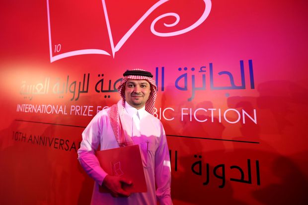Saudi Arabian writer Mohammed Hasan Alwan poses for a photo after winning the 2017 International Prize for Arabic Fiction in Abu Dhabi on April 25, 2017. / AFP PHOTO / STRINGER ORG XMIT: 1751