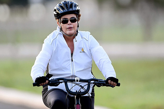 Dilma Rousseff rides her bicycle while escorted by her security detail in the area of the Alvorada Palace in Brasilia 