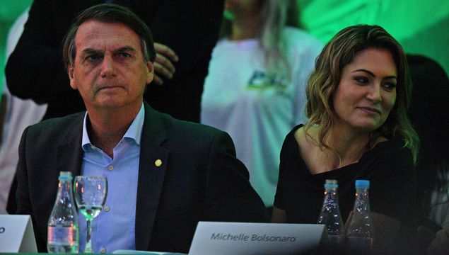 Federal deputy Jair Bolsonaro (L) is accompanied by his wife Michelle Bolsonaro as he launches his campaign for the presidency of Brazil for October's national election during the national convention of the Social Liberal Party (PSL), in Rio de Janeiro