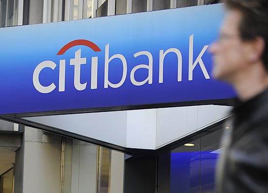 ORG XMIT: ED2548 (FILES) A man walks by a Citibank branch at the US bank Citigroup world headquarters on Park Avenue, in New York, in this November 17, 2008 file photo. Citigroup announced December 5, 2012 that it would cut 11,000 jobs in a move boost efficiency, with most of the cuts in its global consumer banking division. "Due to this repositioning, Citi expects to record pre-tax charges of approximately $1 billion in the fourth quarter of 2012 and approximately $100 million of related charges in the first half of 2013," the company said. AFP PHOTO/Emmanuel Dunand