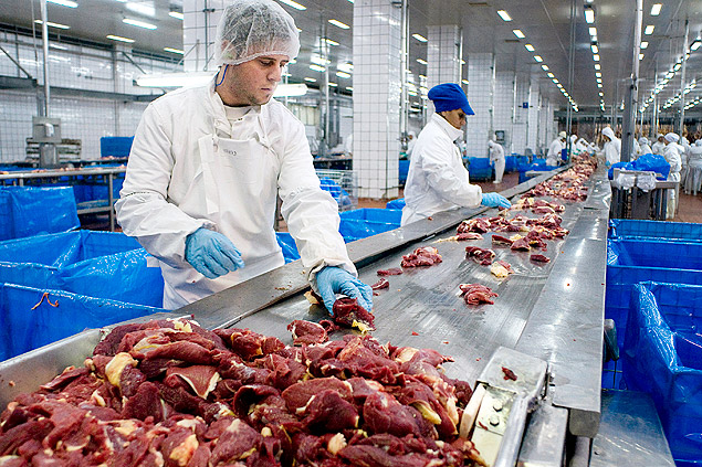 Employees work at a JBS meat processing plant in Rosario, Argentina