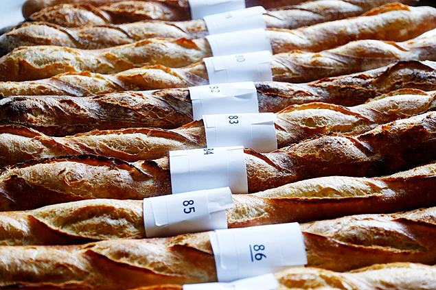 Baguettes, French bread, selected in the competition for the 'Grand Prix de la Baguette de la Ville de Paris' (Best Baguette of Paris 2013) annual prize are displayed in a row at the Chambre Professionnelle des Artisans Boulangers Patissiers in Paris April 25, 2013. The baguette is a French cultural symbol par excellence and the competition saw 203 Parisian bakers who compete for recognition as finest purveyor of one of France's most iconic staples. The baguettes are registered, given anonymous white wrappings and an identification number. They are then carefully weighed and measured to ensure they do not violate the contest's strict rules. 52 entries were withdrawn for failing to measure between 55-70cm long or not matching the acceptable weight of between 250-300g. Every year, the winner earns the privilege of baking bread for the French President. REUTERS/Charles Platiau (FRANCE - Tags: FOOD SOCIETY) ORG XMIT: CHP13