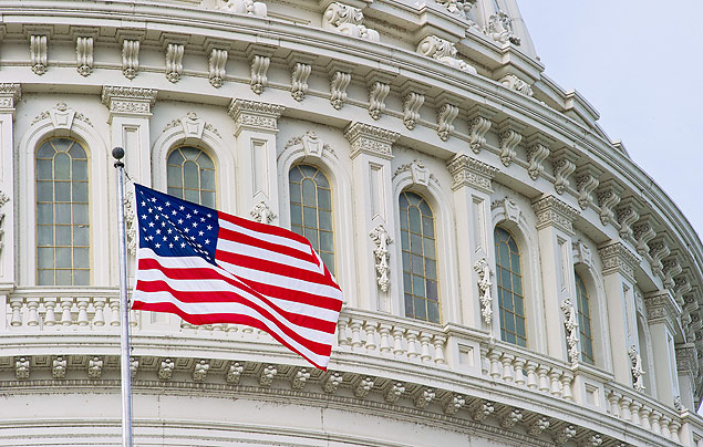The US flag flies over the US Capitol October 16, 2013 in Washington, DC. US lawmakers embarked on another day of high-stakes political brinkmanship Wednesday, battling to scrape together an eleventh hour deal to protect Washington's battered financial standing. At midnight (0400 GMT), the US economy will sail into uncharted waters and the Treasury will no longer be able to guarantee it will be able to meet its obligations and avert a devastating debt default. The only way to avert this peril, which could send global markets into turmoil and threaten another recession, would be for Congress to agree to raise the US government's $16.7 trillion debt ceiling. TOPSHOTS/AFP PHOTO/ Karen BLEIER ORG XMIT: KBS033