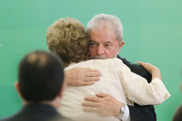 Luiz Inacio Lula da Silva hugs Dilma Rousseff after he swore as chief of staff in Brasilia