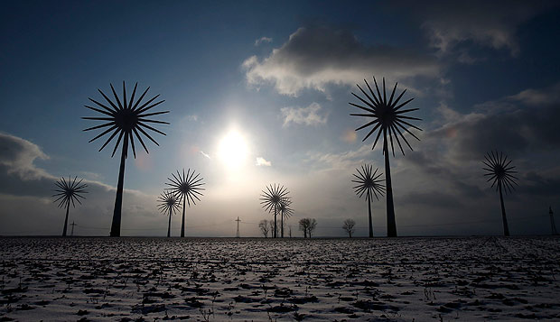 File multiple exposure photo of wind turbines at the German village of Feldheim February 21, 2013. Angela Merkel's best hope of saving her bold energy revolution may lie in a coalition with the centre-left Social Democrats (SPD), who could agree to modest cuts to costly incentives for green power which are, paradoxically, driving up energy prices. The German chancellor's experiment to wean Europe's biggest economy off nuclear and fossil fuels and push it into renewables is at risk because generous subsidies have proved so popular with investors in green power that the country is straining under the cost. TO GO WITH STORY GERMANY-COALITION/ENERGY REUTERS/Tobias Schwarz/Files (GERMANY - Tags: POLITICS ENERGY) ORG XMIT: BER98