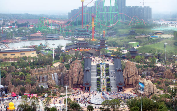 Visitors make their way toward the Nanchang Wanda Park theme park during its grand opening day in Nanchang in southeastern China's Jiangxi province, Saturday, May 28, 2016. China's largest private property developer, the Wanda Group, opened an entertainment complex on Saturday that it's positioning as a distinctly homegrown rival to Disney and its $5.5 billion Shanghai theme park opening next month. (AP Photo/Mark Schiefelbein) ORG XMIT: XMAS102