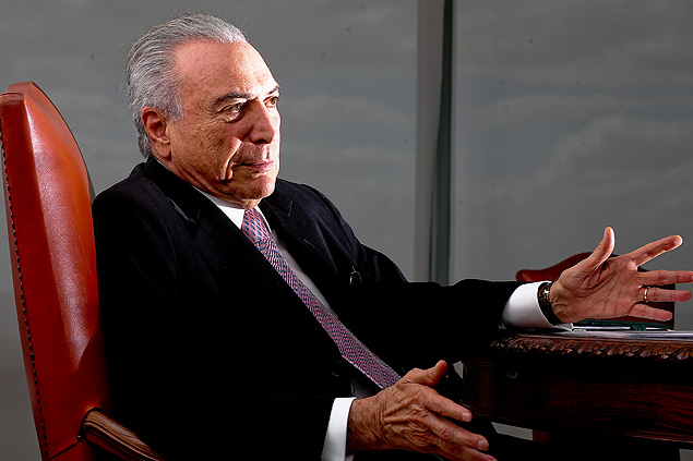 Interim president Michel Temer gestures during an exclusive interview with Folha
