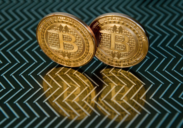 (FILES) This file photo taken in Washington,DC on June 17, 2014 shows bitcoin medals. Bitcoin, a Florida judge says, is not real money. Ironically, that could provide a boost to use of the crypto-currency which has remained in the shadows of the financial system. The July 22, 2016 ruling by Miami-Dade Circuit Judge Teresa Pooler means that no specific license is needed to buy and sell bitcoins.The judge dismissed a case against Michel Espinoza, who had faced money laundering and other criminal charges for attempting to sell $1,500 worth of bitcoins to an undercover agent who told the defendant he was going to use the virtual money to buy stolen credit card numbers. / AFP PHOTO / KAREN BLEIER ORG XMIT: KBS965