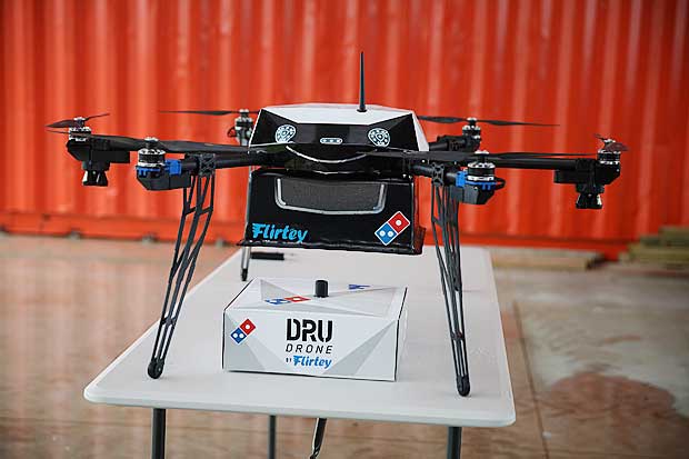 A pizza delivery drone sits with a pizza box underneath before a test flight in Auckland, New Zealand, August 25, 2016. Domino's/Handout via REUTERS ATTENTION EDITORS - THIS IMAGE WAS PROVIDED BY A THIRD PARTY. EDITORIAL USE ONLY. NO RESALES. NO ARCHIVE. ORG XMIT: SYD98