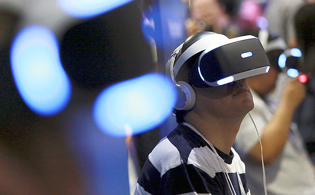 Visitors try out Sony's PlayStation VR headgear devices at the Tokyo Game Show in Makuhari, near Tokyo, Thursday, Sept. 15, 2016. Virtual reality has arrived for real at the Tokyo Game Show, one of the world's biggest exhibitions for the latest in fun and games. Japanese electronics and entertainment maker Sony Corp., whose game console is the top-seller in its home market of Japan, is taking center stage. (AP Photo/Eugene Hoshiko) ORG XMIT: XEH112