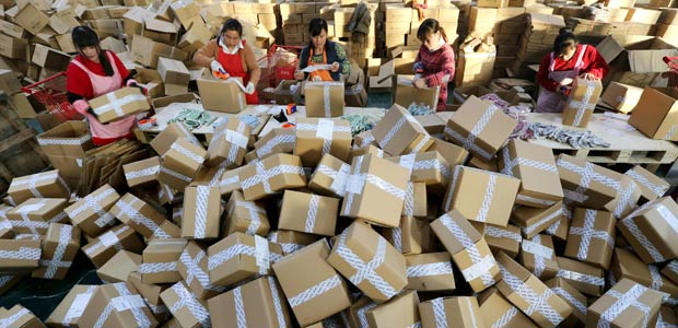 Workers prepare packages for delivery at a sorting center in Lianyungang, Jiangsu province during the Singles Day online shopping festival on November 11, 2016. Chinese shoppers unleashed a record deluge of cash online for Singles Day on November 11, Alibaba said, spending RMB 120.7 billion (USD17.8 billion) with the e-commerce giant in the world's biggest online shopping promotion. / AFP PHOTO / STR / China OUT ORG XMIT: GB6949