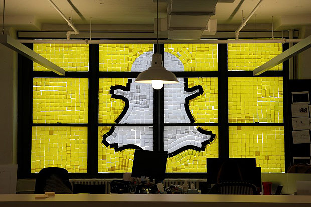 An image of the Snapchat logo created with Post-it notes is seen in the windows of Havas Worldwide at 200 Hudson Street in lower Manhattan, New York, U.S., May 18, 2016, where advertising agencies and other companies have started what is being called a 