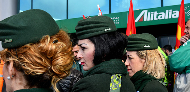 (FILES) This file photo taken on March 20, 2017 shows Alitalia air transport employees gathering for a protest rally at Rome's Fiumicino airport. Alitalia's workers are voting today on April 24, 2017 on a referendum to find an agreement on job and pay cuts. Prime Minister Paolo Gentiloni warned last week that without the plan's approval 