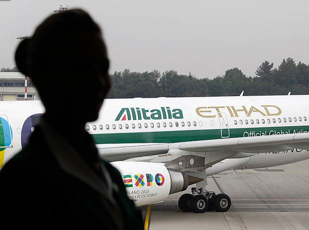 FILE - In this Monday, Oct. 20, 2014 file photo, an Alitalia plane waits on the tarmac of the Malpensa international airport, in Milan, Italy. Alitalia says it’s still flying normally for now, after employees rejected a government-brokered deal of salary cuts and layoffs cuts aimed at avoiding bankruptcy for Italy’s financially troubled flagship airline. (AP Photo/Antonio Calanni, File) ORG XMIT: ROM102