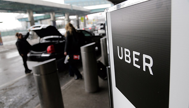 FILE - In this Wednesday, March 15, 2017, file photo, a sign marks a pickup point for the Uber car service at LaGuardia Airport in New York. Ubers first report on employee diversity shows low numbers for women, especially in technology positions. Ubers report doesnt count drivers as employees. (AP Photo/Seth Wenig, File) ORG XMIT: NYBZ216