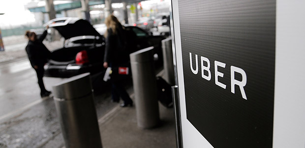 FILE - In this Wednesday, March 15, 2017, file photo, a sign marks a pickup point for the Uber car service at LaGuardia Airport in New York. Uber's first report on employee diversity shows low numbers for women, especially in technology positions. Uber's report doesn't count drivers as employees. (AP Photo/Seth Wenig, File) ORG XMIT: NYBZ216