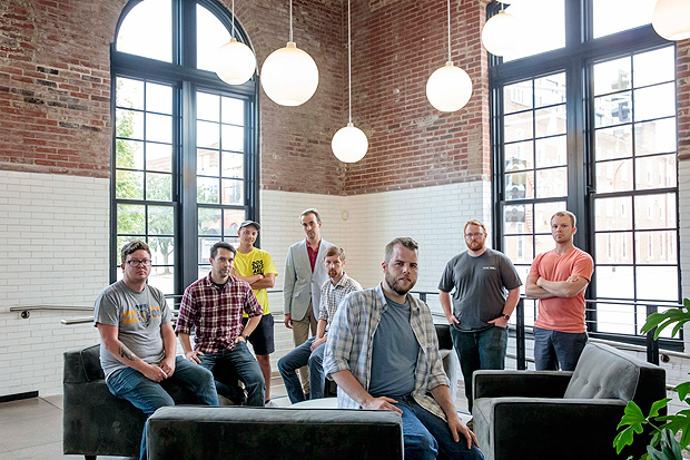 From left: Brian Pritchett, Patrick Lloyd, George Lum, Wil Thuston, Zach Hartwick, Peter Sussman, Kyle Jones, and Ben Loos at the offices of Fusion Marketing in St. Louis, June 19, 2017. Sussman, a software developer, began with around $800 worth of Bitcoin, which he earned selling art and blog posts online. He used his Bitcoin to first invest in a project called BitShares. Then he bought into the Ethereum virtual currency, Ether. As the value of Ether soared in recent months, Sussman got a ten times return on his original money (Whitney Curtis/The New York Times)