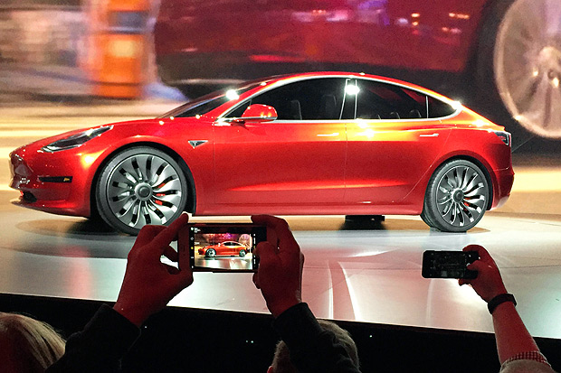 In this March 31, 2016, file photo, Tesla Motors unveils the new lower-priced Model 3 sedan at the Tesla Motors design studio in Hawthorne, Calif. Electric car maker Tesla said on Monday, July 3, 2017, that its Model 3 car will go on sale on Friday. (AP Photo/Justin Pritchard, File) ORG XMIT: BKCD202