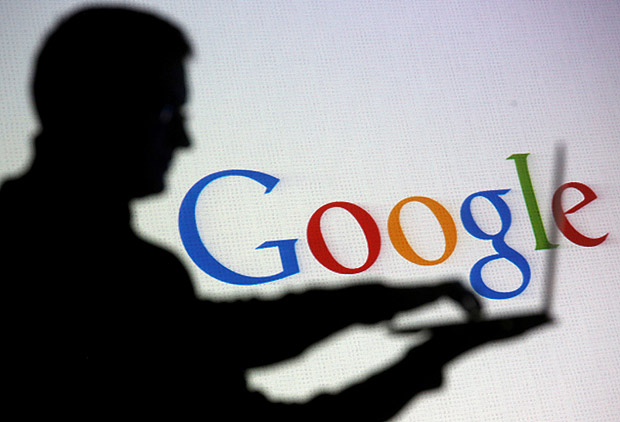 FILE PHOTO: People are silhouetted as they pose with laptops in front of a screen projected with a Google logo, in this picture illustration taken in Zenica October 29, 2014. REUTERS/Dado Ruvic/File Photo ORG XMIT: TOR115