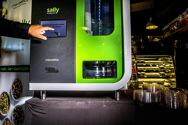 -- PHOTO MOVED IN ADVANCE AND NOT FOR USE - ONLINE OR IN PRINT - BEFORE SUNDAY, OCT. 8, 2017. -- Sally the Salad Robot at a restaurant in Palo Alto, Calif., Sept. 5, 2017. To reduce the risk of food-borne illness resulting from human contact at salad bars, Chowbotics founder Deepak Sekar invented a machine that assembles salads out of precut vegetables stored in canisters and chosen by diners using a touch screen. (Christie Hemm Klok/The New York Times)