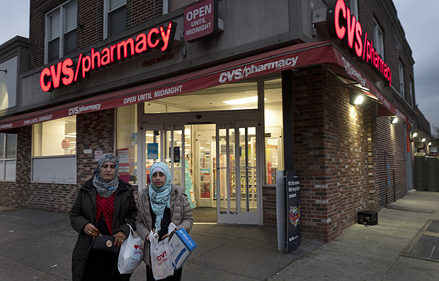 Customers leave a CVS Pharmacy, Sunday, Dec. 3, 2017 in the Brooklyn borough of New York. CVS will buy insurance giant Aetna in a roughly $69 billion deal that will help the drugstore chain reach deeper into customer health care and protect a key client, a person with knowledge of the matter said Sunday. 