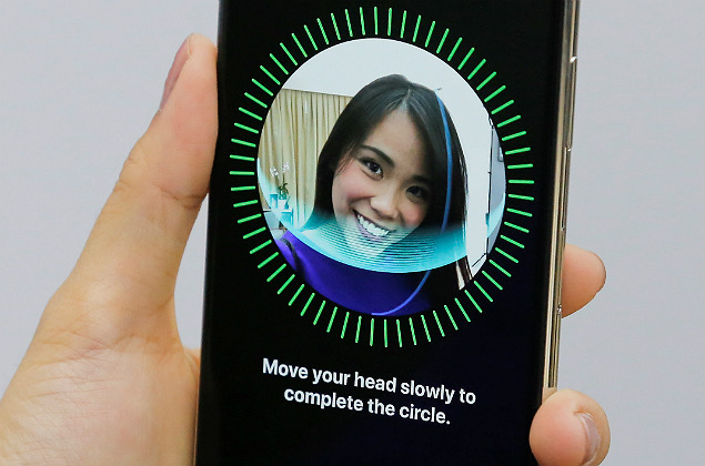 An attendee uses the Face ID function on the new iPhone X during a presentation for the media in Beijing, China October 31, 2017. REUTERS/Thomas Peter ORG XMIT: TPE13