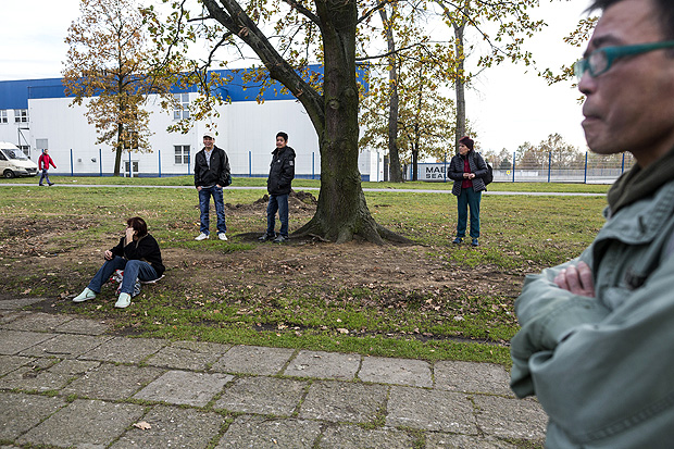 Migrant workers wait for a bus near the Foxconn factory in Pardubice, Czech Republic, Nov. 2, 2017. Employment agencies across the region recruit thousands of migrants for Foxconn and other businesses, with conditions and pay that few in-country nationals would accept. (Milan Bures/The New York Times) ORG XMIT: XNYT165