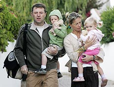 Gerry e Kate McCann carregam os gêmeos Sean e Amelie, irmãos de Madeleine