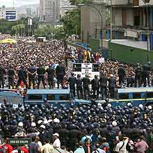 Estudantes protestam em frente a bloqueio policial, em Caracas