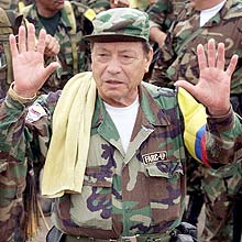** FILE ** Manuel Marulanda, the founder and top leader of the Revolutionary Armed Forces of Colombia, FARC, gestures as he arrives in Los Pozos, southern Colombia, in this Feb. 9, 2001 file photo. Colombia's Defense Minister Juan Manuel Santos tells the weekly magazine Semana in interview published Saturday that Manuel Marulanda may have died in March, citing "a source who has never failed us". Marulanda has led the rebels for more than 40 years.(AP Photo/Ricardo Mazalan)
