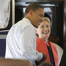 Democratic presidential candidate Sen. Barack Obama, D-Ill., talks to Sen. Hillary Rodham Clinton, D-N.Y., on his campaign charter, Wednesday, July 9, 2008, in Washington. (AP Photo/Jae C. Hong)