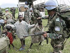 Uruguayan United Nations soldiers play with children as they deploy to an observation post near the village of Kibati some 12 kilometers north of Goma in eastern Congo, Wednesday, Oct. 29, 2008. The U.N. peacekeeping force in Congo is stretched to the limit with an upsurge in fighting in the volatile east and needs more troops quickly, the top U.N. envoy to Congo, Alan Doss said Tuesday.(AP Photo/Karel Prinsloo) 