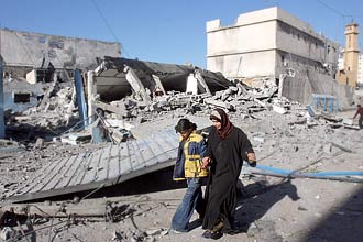 Palestina e filha passam por escombros de prdio usado pelos radicais do Hamas que foi destrudo pelo Exrcito israelenses
