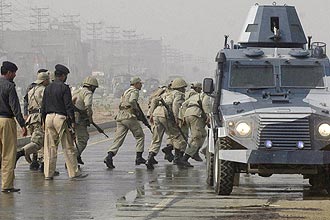 Foras de segurana correm em direo  academia de cadetes em Manawa depois de um ataque reivindicado pelo Taleban